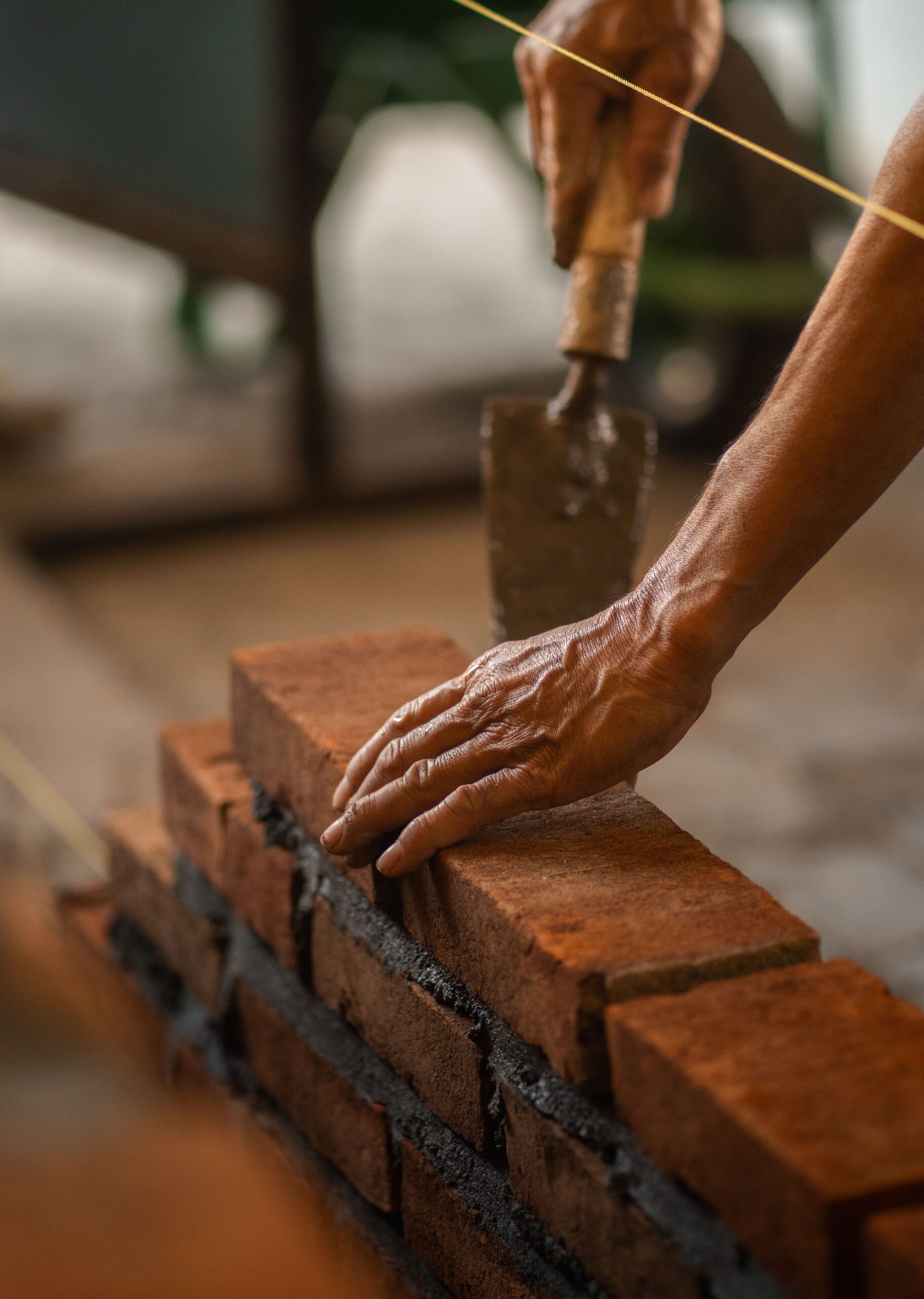 Tradesman applying mortar during a chimney repair and repointing job